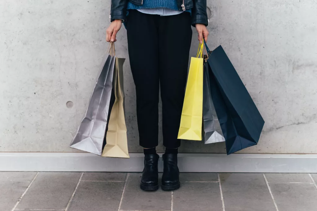 Woman With Shopping Bags, Grey Wall Background