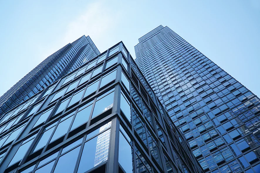 Low Angle View On Modern Office Building With Blue Glass Windows